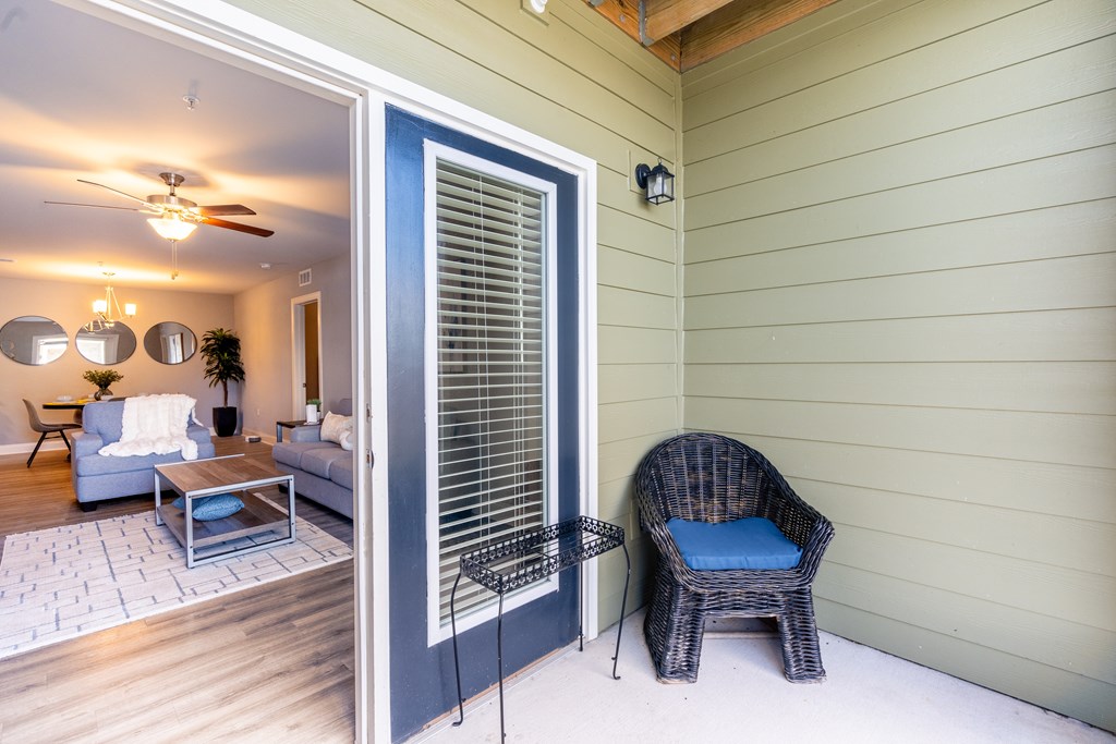 A patio with a chair and a table.
