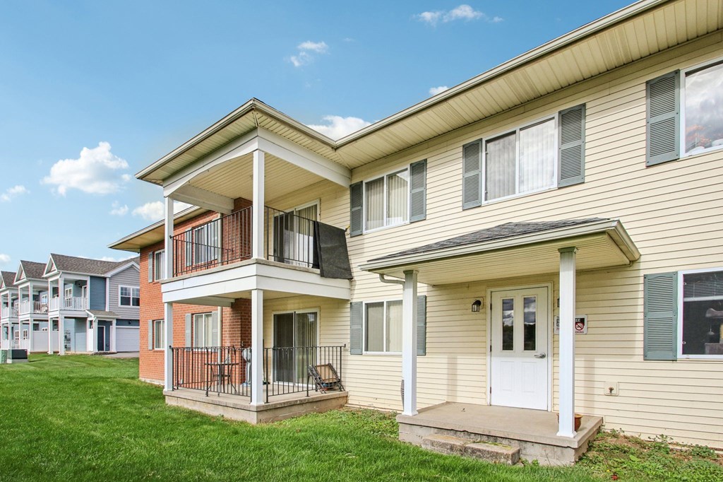 A row of houses with a blue sky in the background.