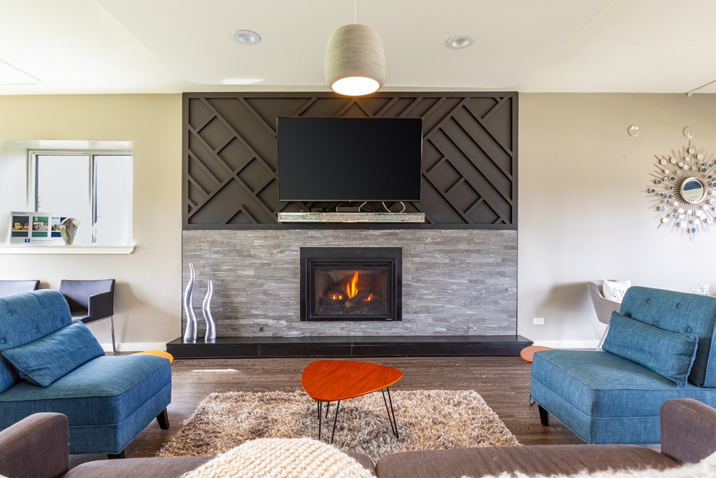 A modern living room with a fireplace and a flat screen TV mounted above it.