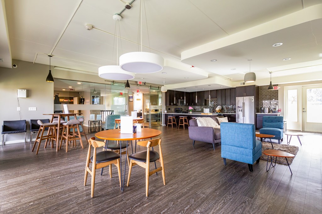 A modern dining room with a wooden table and chairs.