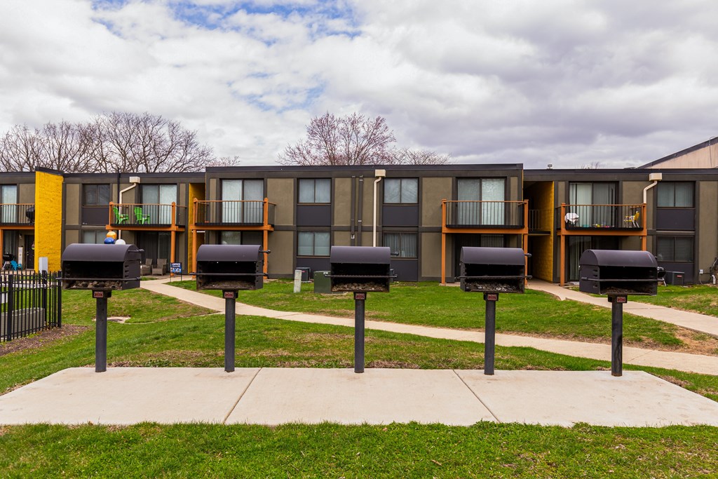 A series of mailboxes in front of apartment buildings.