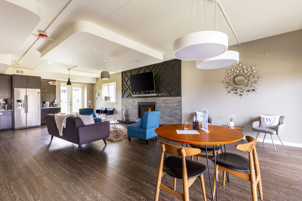 A modern living room with a fireplace and a dining table set up.