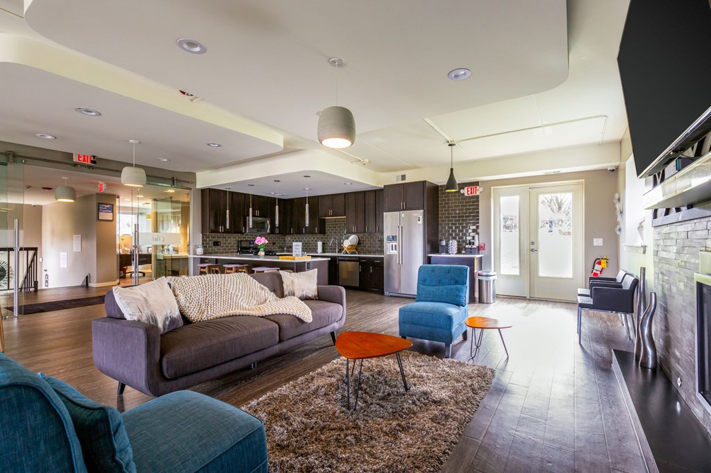 A living room with a grey couch and a blue chair.