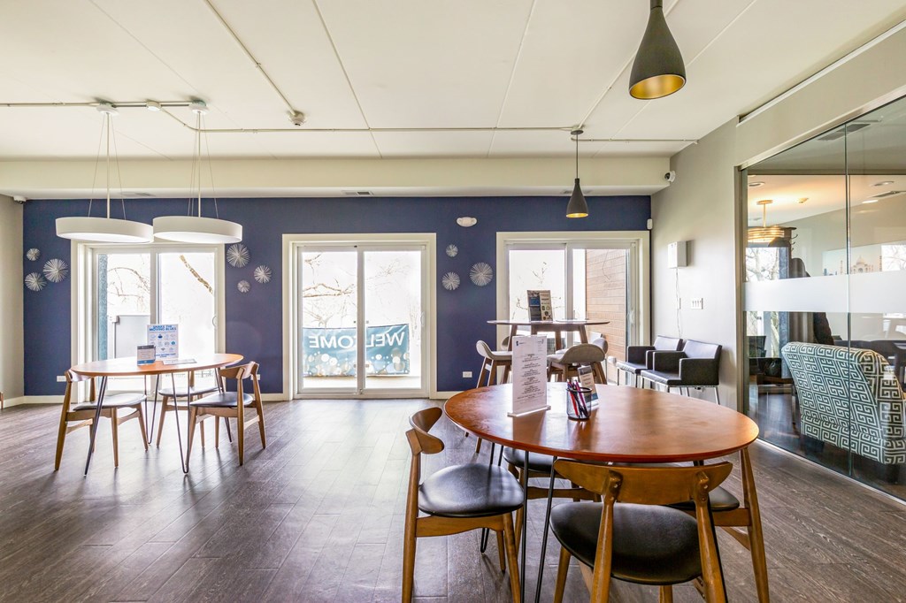 A room with a round wooden table and chairs.