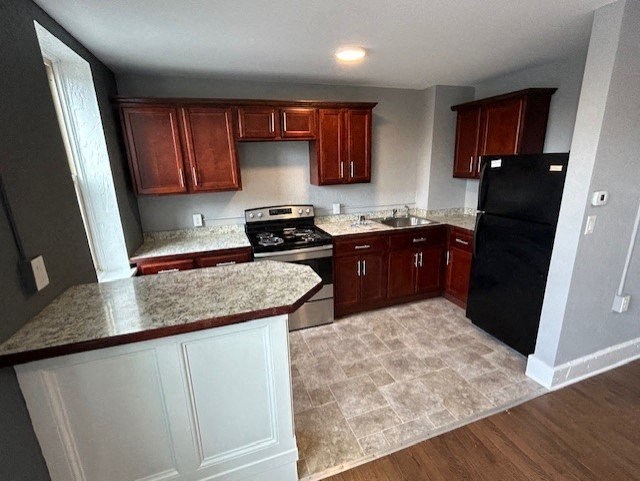 a kitchen with wooden cabinets and black appliances