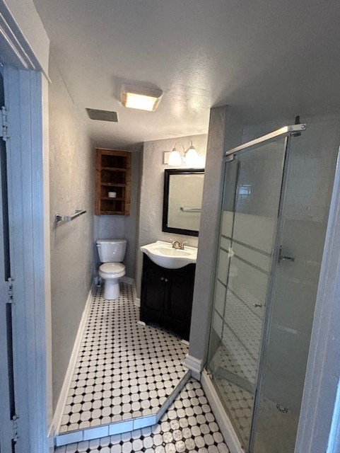 a small bathroom with a sink toilet and a shower