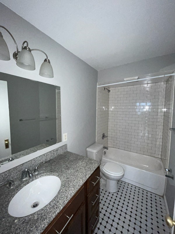 a bathroom with a toilet and a sink and a shower