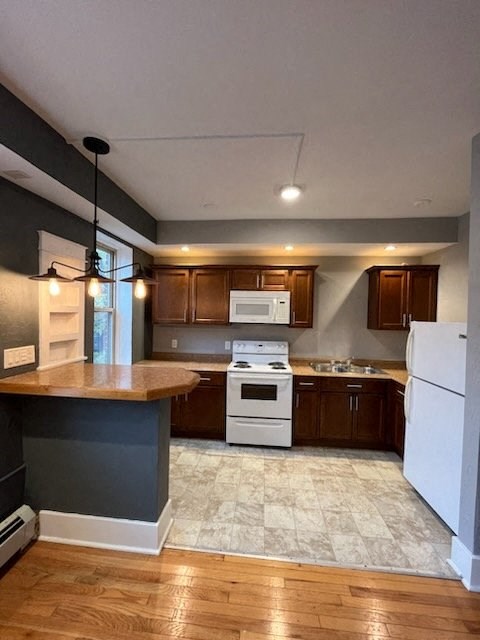 a kitchen with white appliances and wooden cabinets