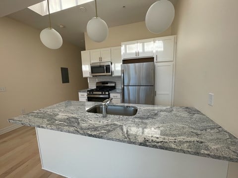 a kitchen with granite counter tops and stainless steel appliances