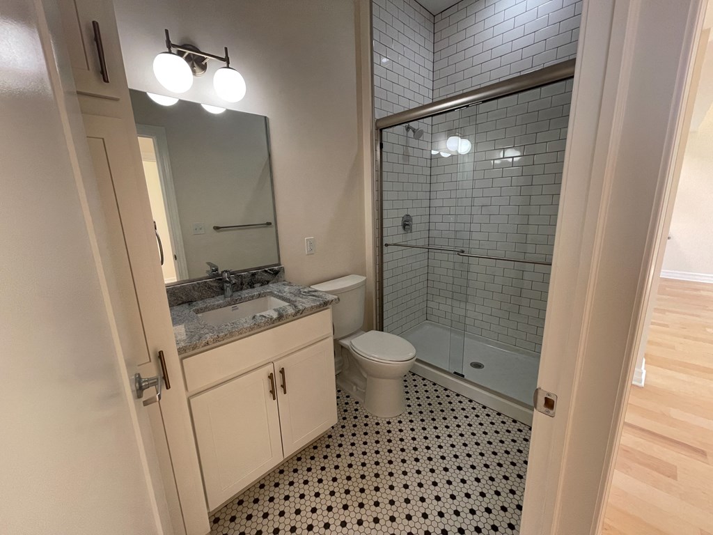 a bathroom with a toilet and a sink and a shower