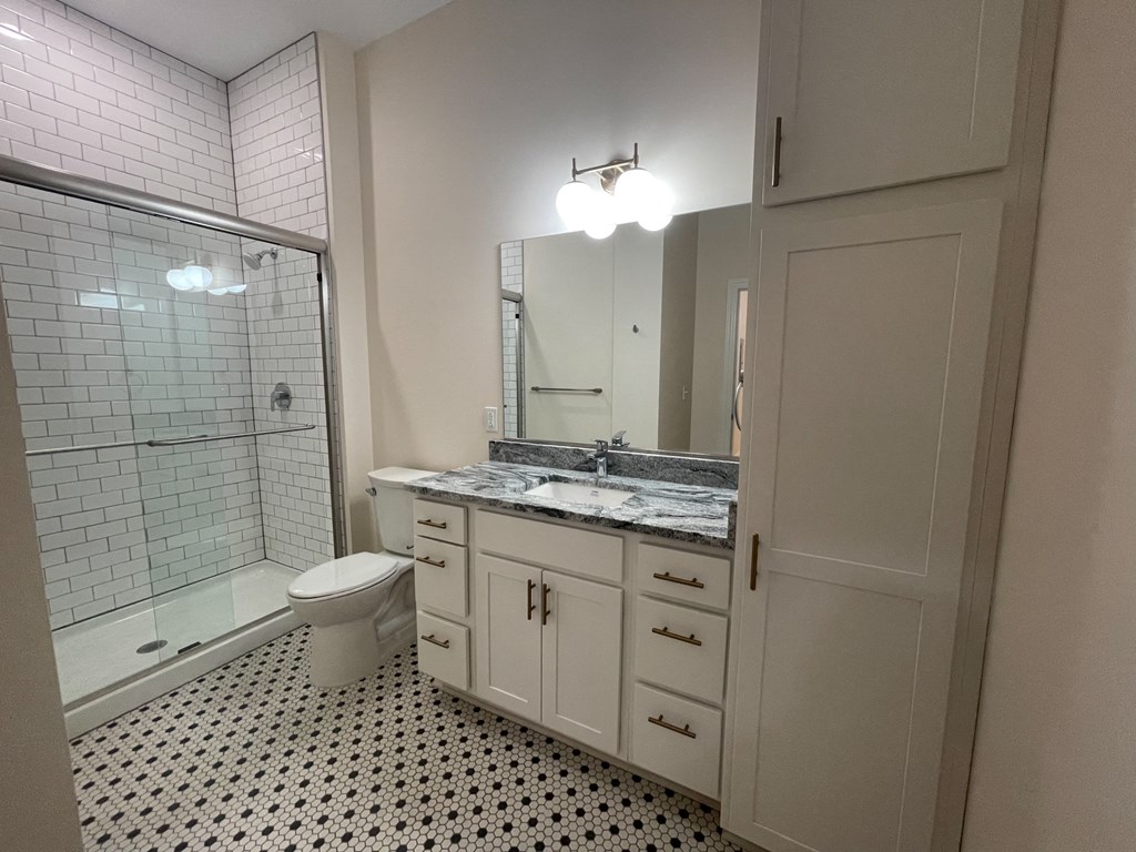 a bathroom with a sink toilet and shower