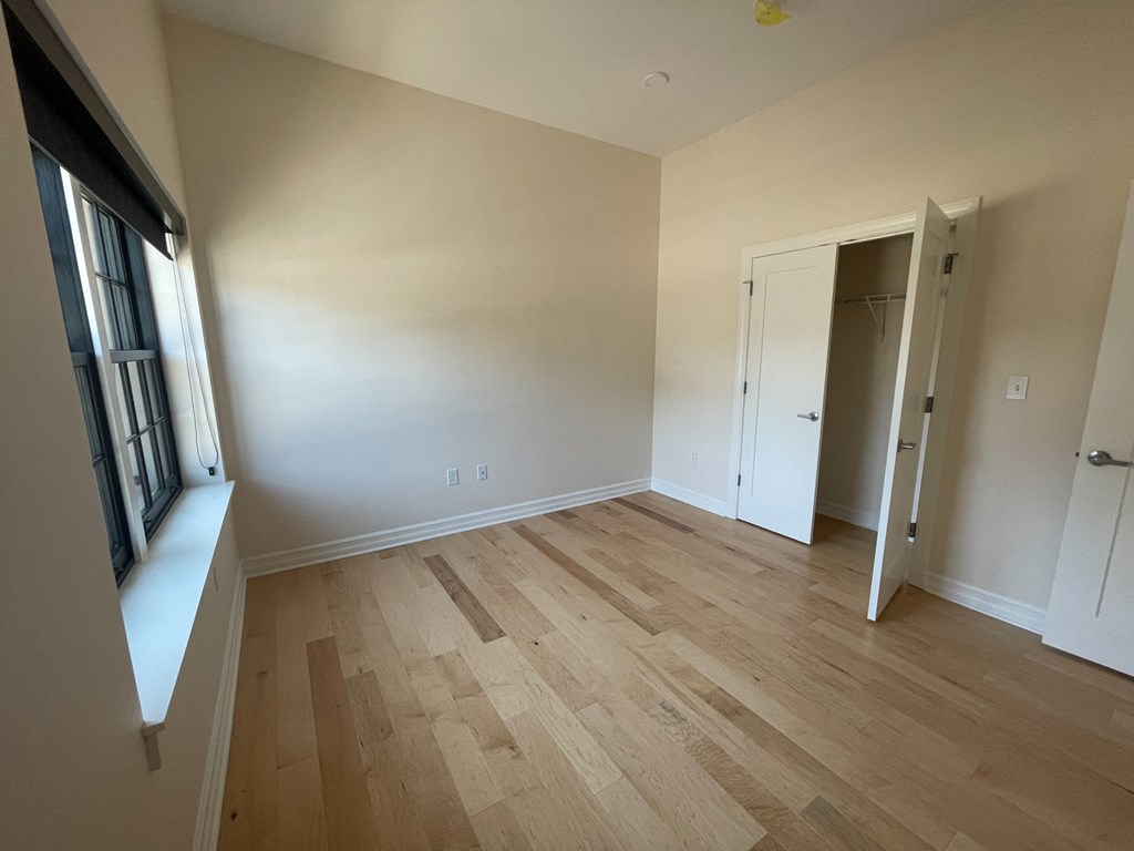 a living room with wood flooring and a window