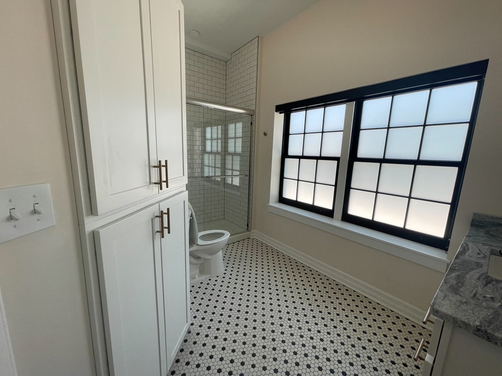 a small bathroom with a toilet and a window