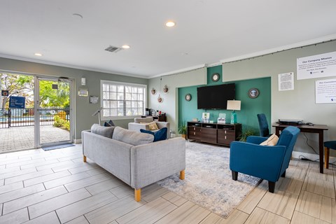 A living room with a grey couch and a blue chair.
