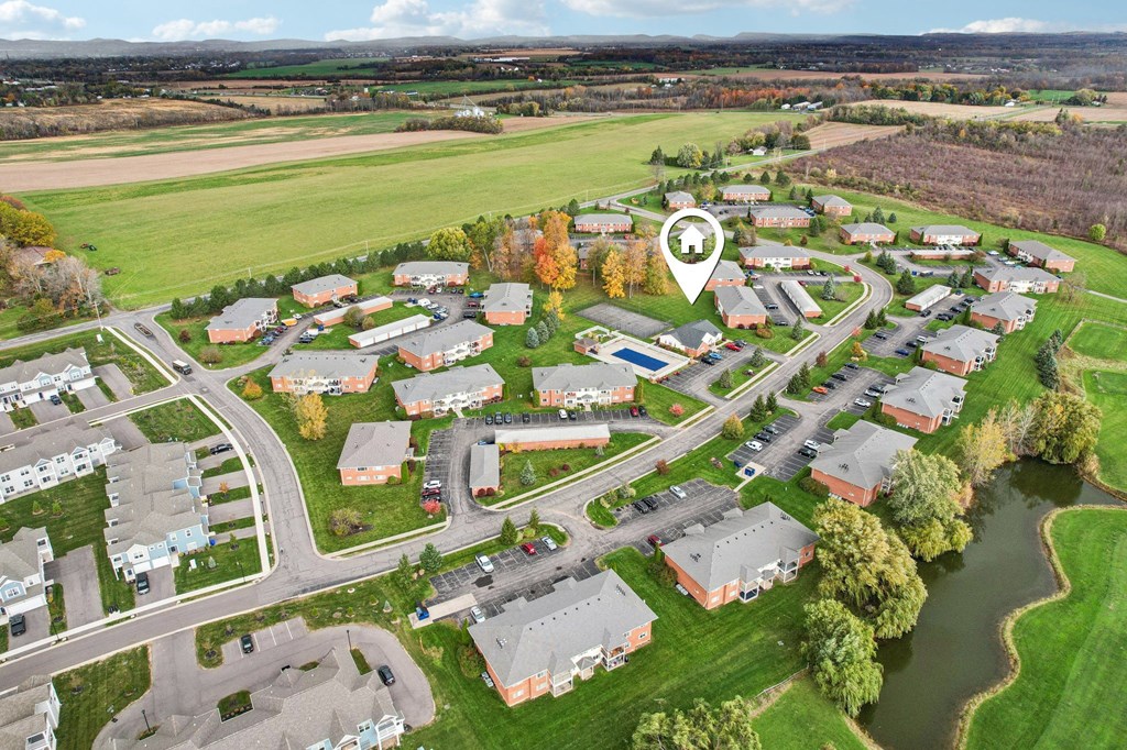 A bird's eye view of a residential area with a river running through it.
