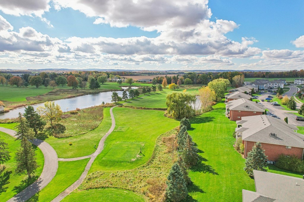 A beautiful landscape with a river, houses, and a clear sky.