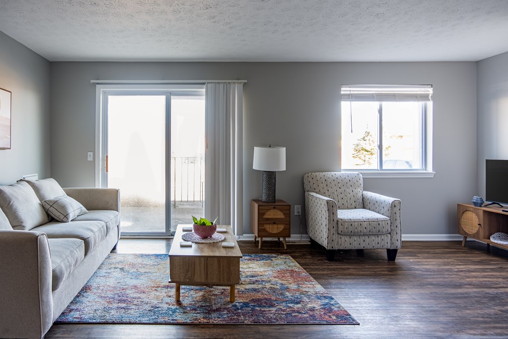A living room with a couch, chair, and table at Centerpointe Apartments, Canandaigua, 14424