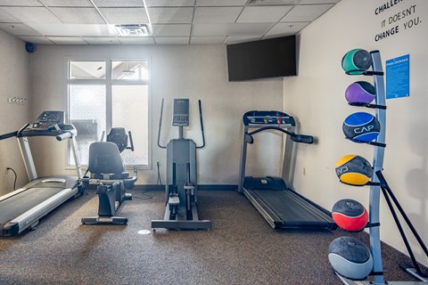 A gym with a sign that says "Challenge doesn't change you."