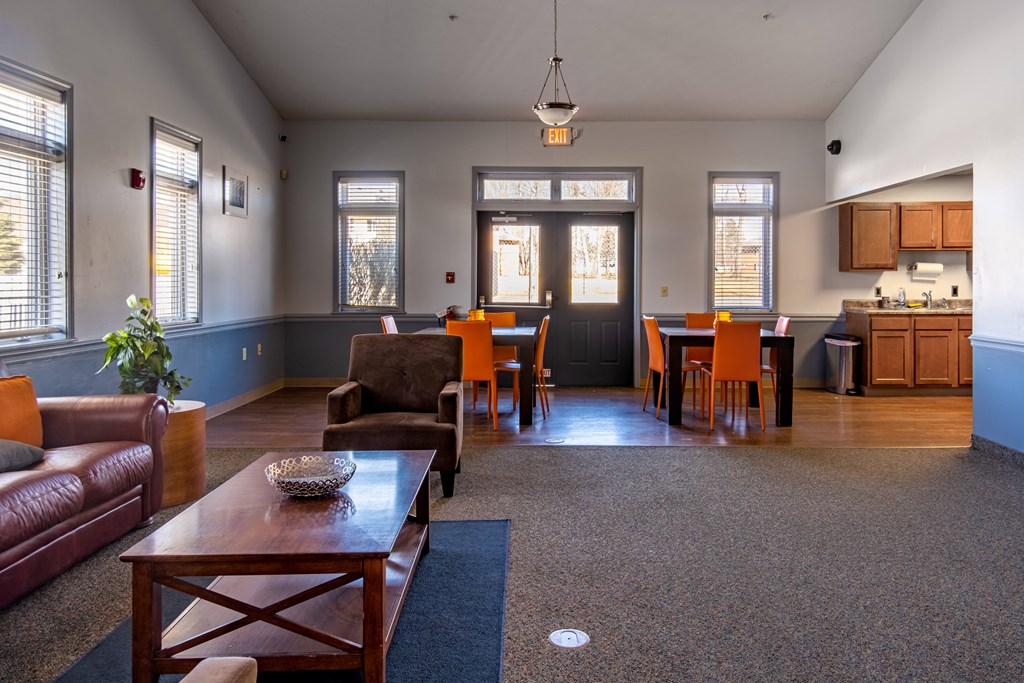 A living room with a brown leather couch and a wooden coffee table at Centerpointe Apartments, Canandaigua, NY, 14424