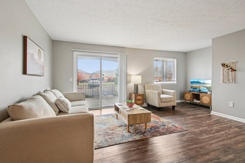 A living room with a couch, chairs, and a coffee table.