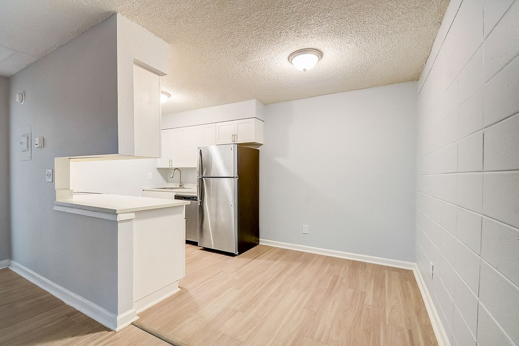 an empty kitchen with a stainless steel refrigerator at Fernwood Grove Apartments at 4900 MacDill Ave in Tampa, Florida