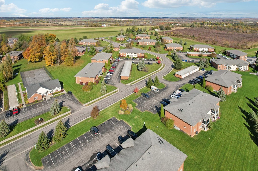 A large building complex with a parking lot in front.