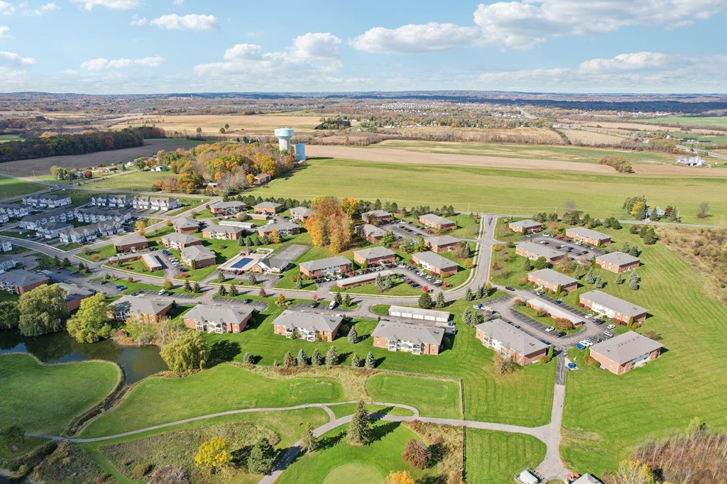 A bird's eye view of a residential area with houses and a river.