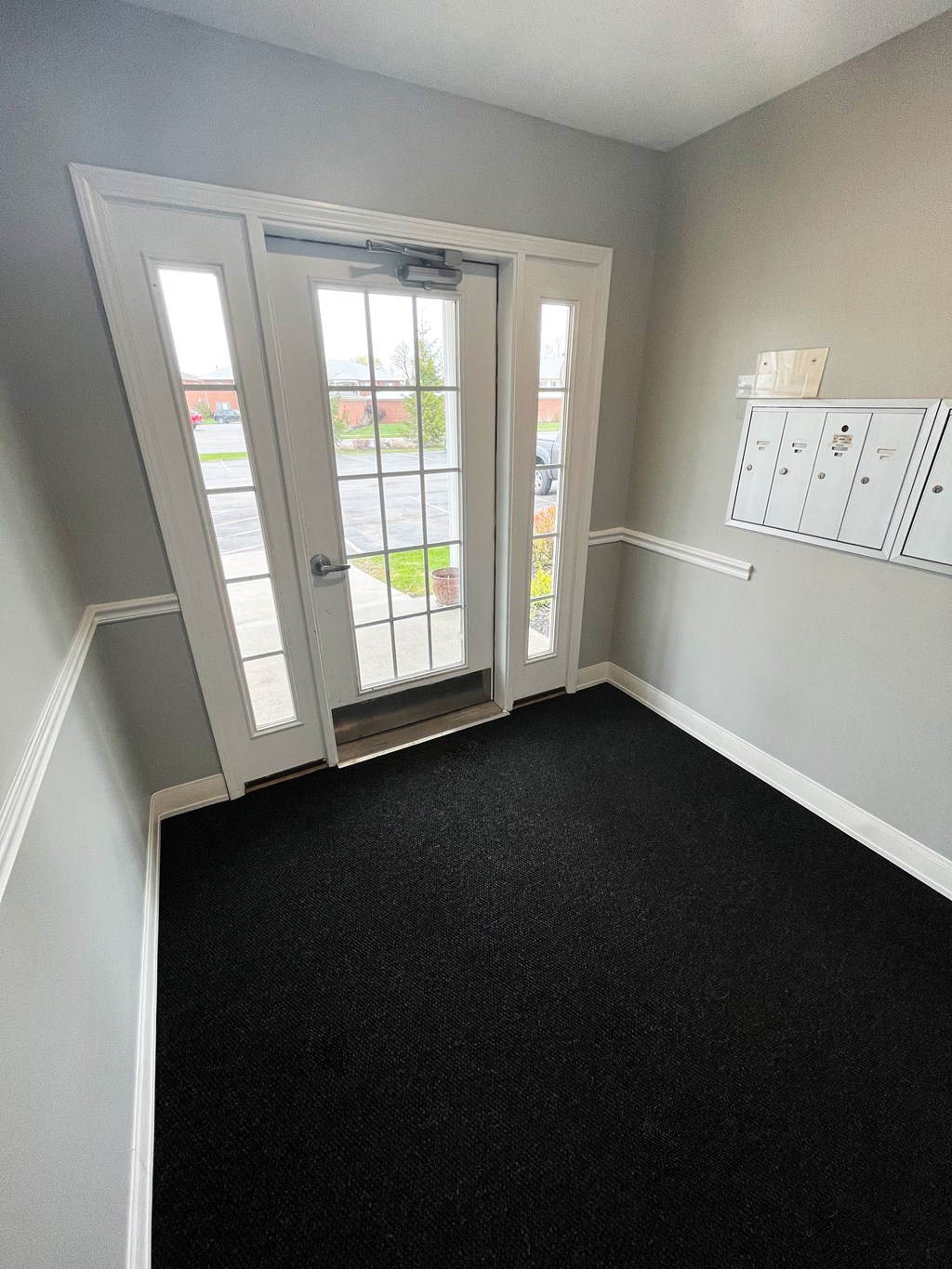 an empty room with a door and a windowat Centerpointe Apartments, Canandaigua, New York