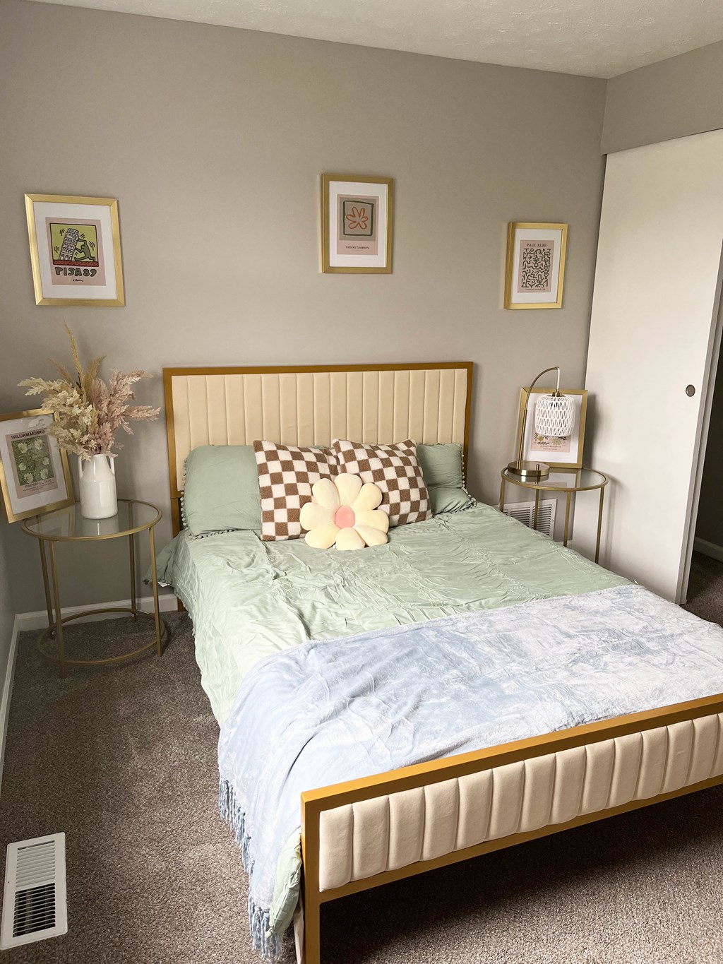a bedroom with grey walls and a bed with a green comforterat Centerpointe Apartments, Canandaigua, New York