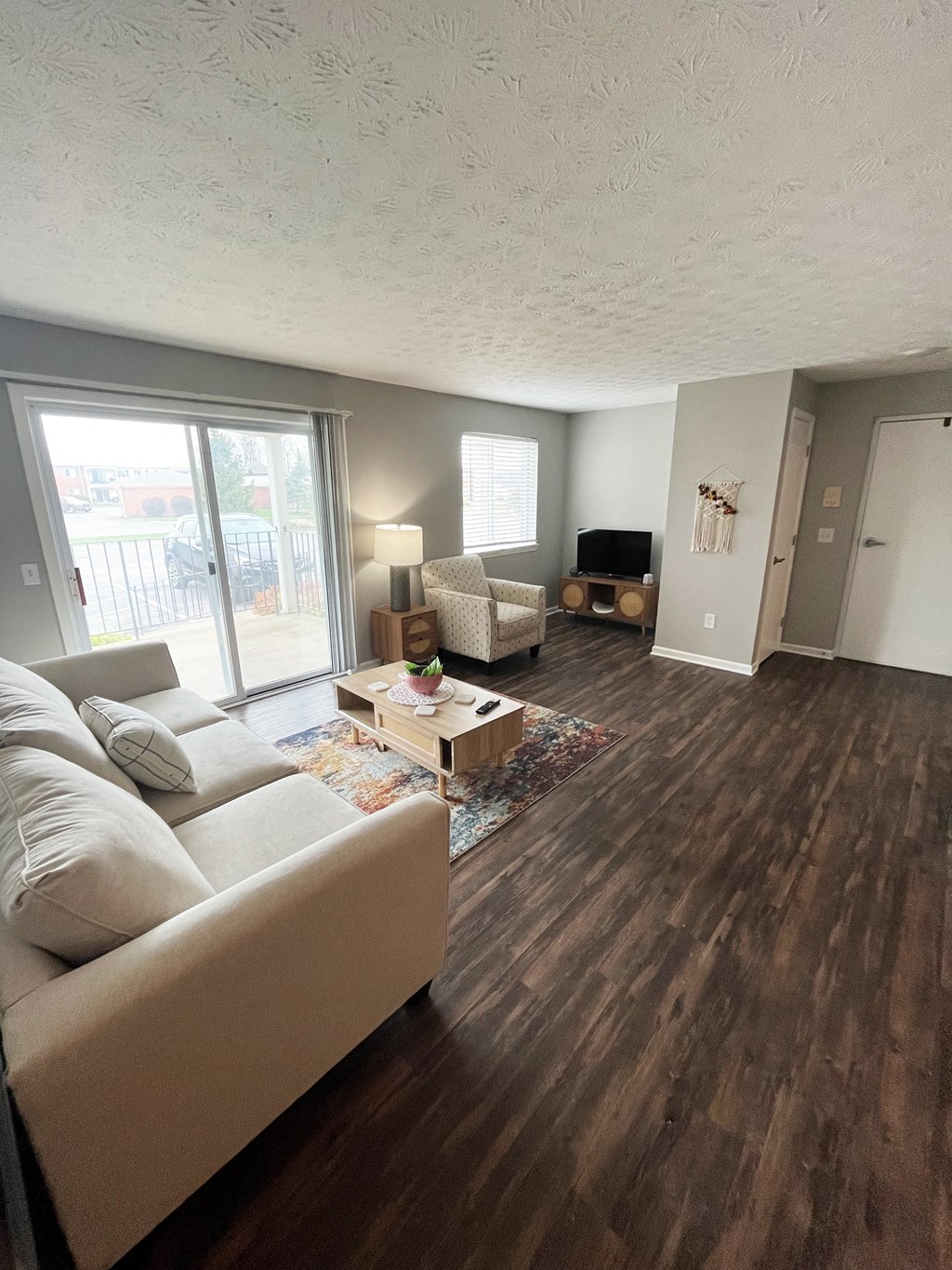 a living room with hardwood floors and a sliding glass doorat Centerpointe Apartments, Canandaigua, NY, 14424