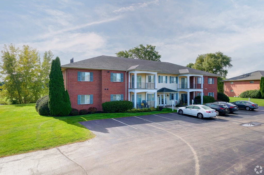 a large brick house with cars parked in front of it at Centerpointe Apartments, Canandaigua, NY, 14424