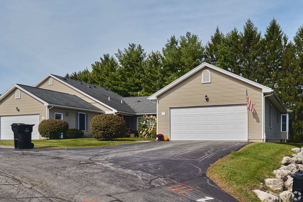 a house with a driveway and a white garage door at Centerpointe Apartments, Canandaigua, NY