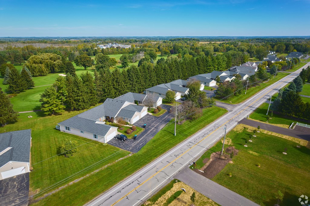 an aerial view of a neighborhood of houses with green grass and trees at Centerpointe Apartments, New York