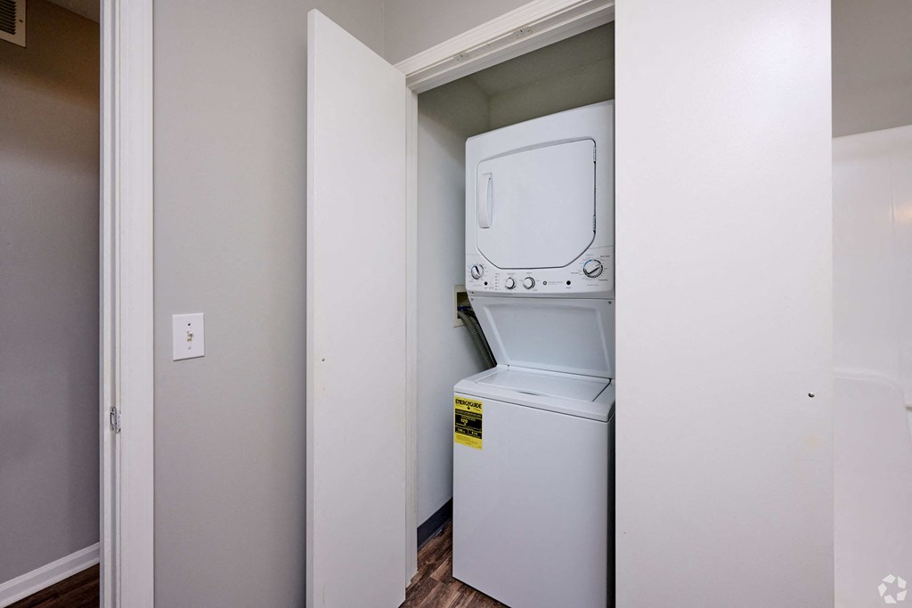 a small laundry room with a washer and dryer in it at Centerpointe Apartments, Canandaigua, New York