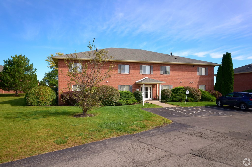 a large brick house with a driveway in front of it at Centerpointe Apartments, Canandaigua, NY, 14424