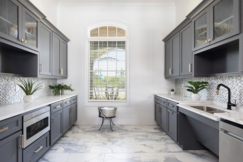 a kitchen with blue cabinets and a window