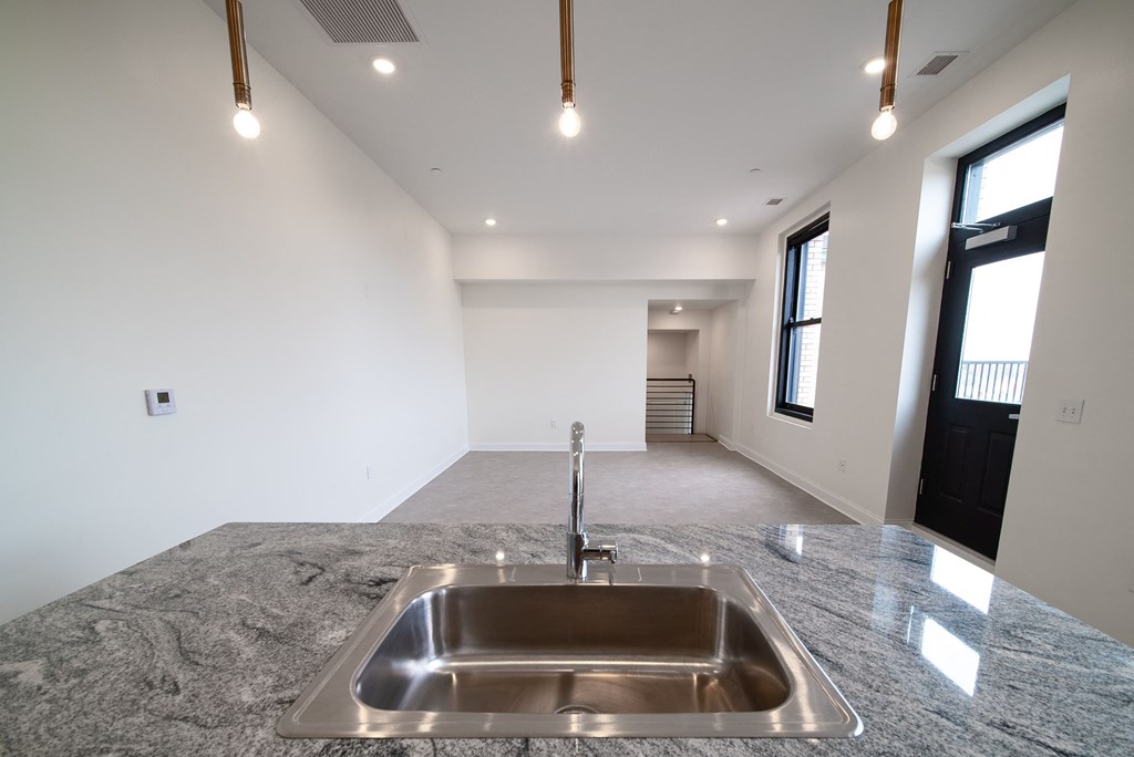 a kitchen with a sink in a new home