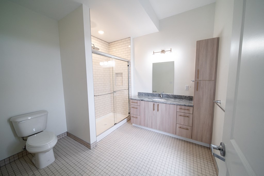 an empty bathroom with a toilet and a shower