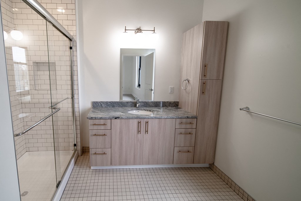 an empty bathroom with a sink and a shower