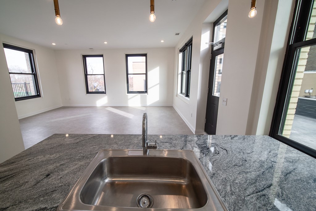 an empty living room and kitchen in a new home