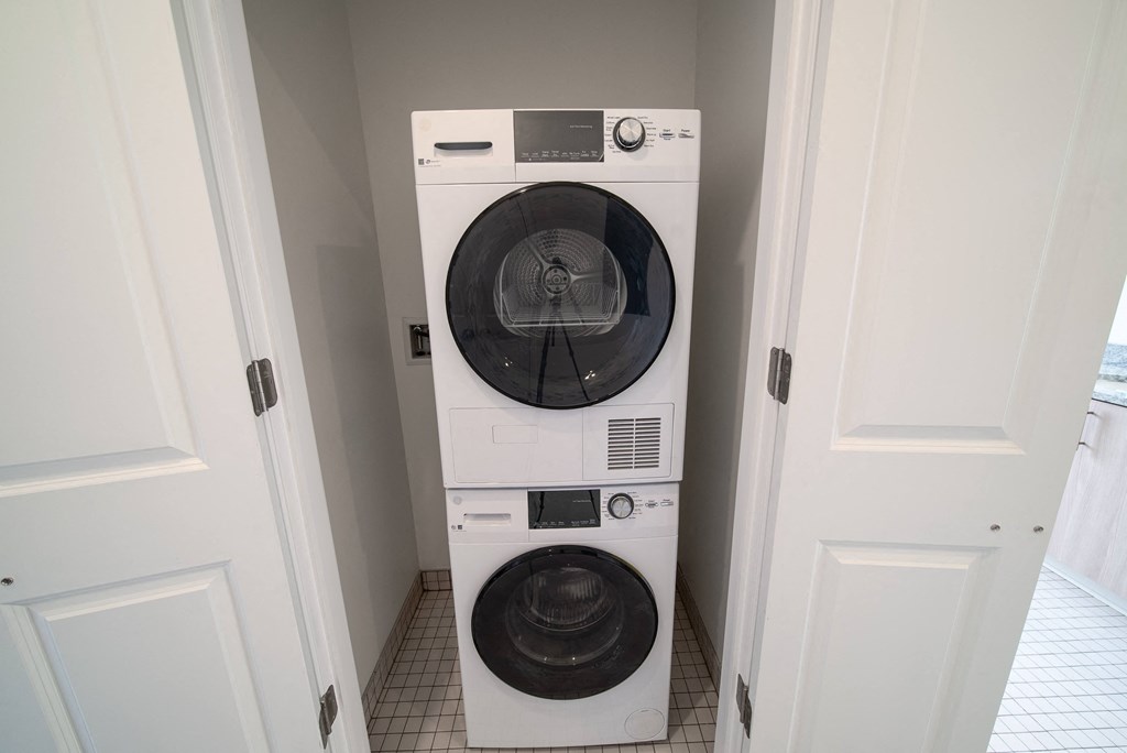 a white washer and dryer in a small laundry room