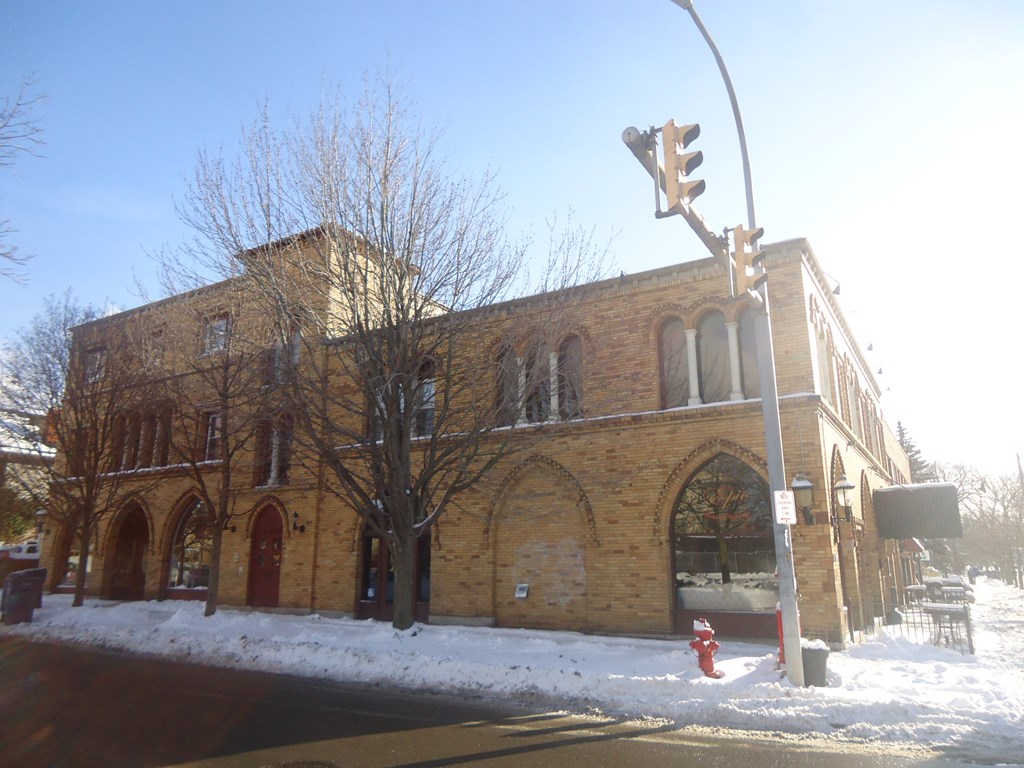 an old brick church with a traffic light in the snow