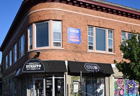 A building with a sign that says Breezy Burrito.