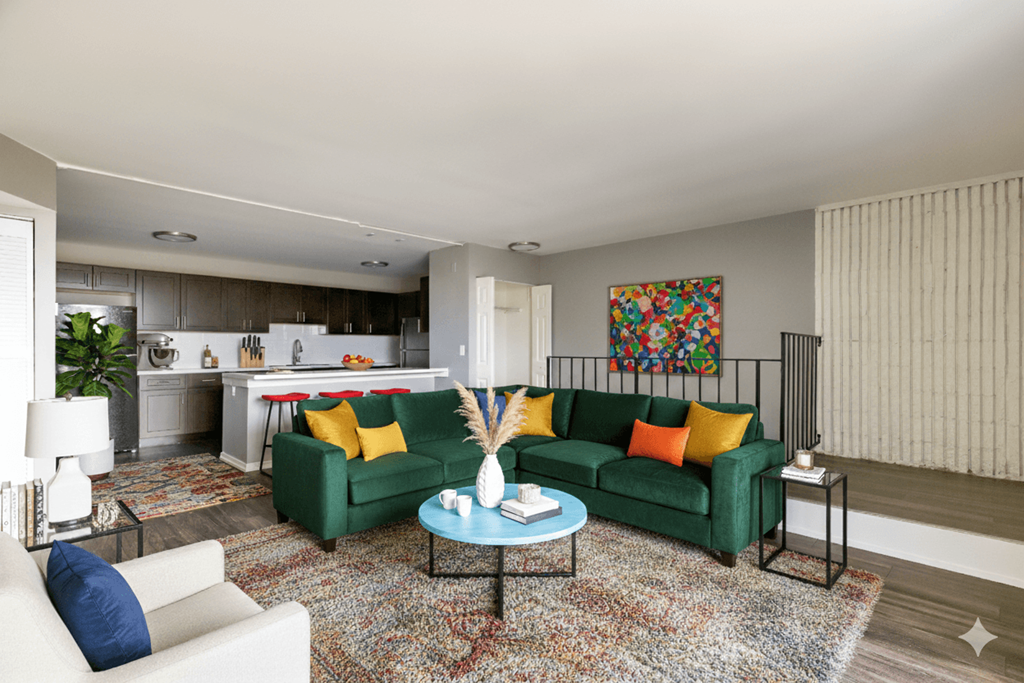 A living room with a green couch and a white chair.