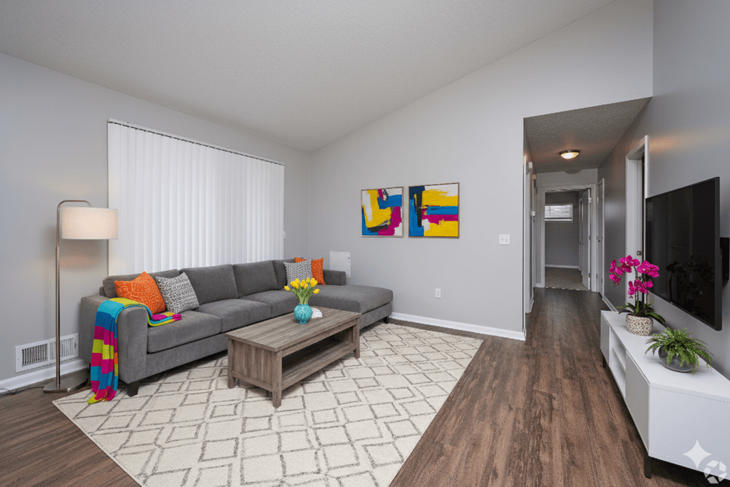 A living room with a grey couch and a coffee table.