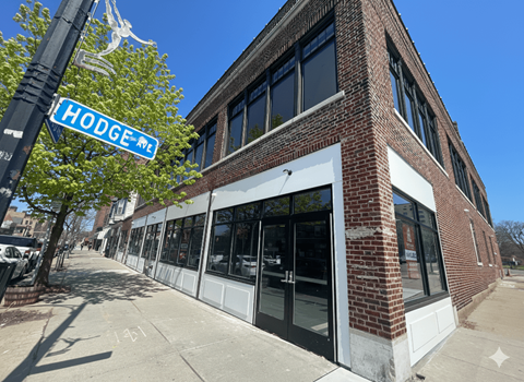 A street view of a building with a sign that says Hodge Me.
