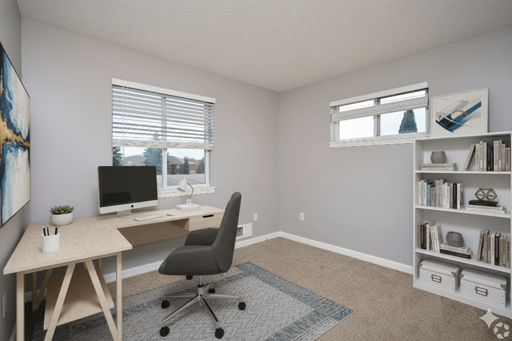 A room with a desk, chair, and bookshelf.