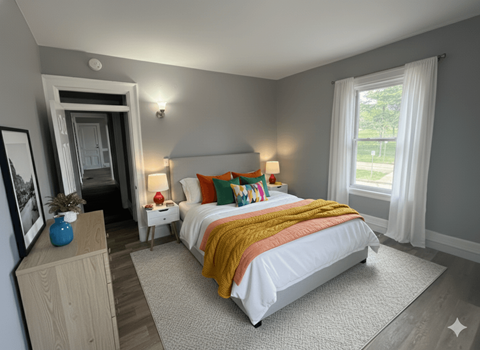 A bedroom with a large bed and a dresser.