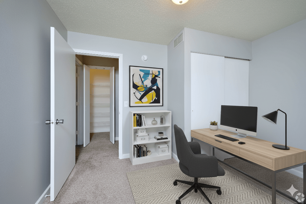 A room with a desk, chair, and bookshelf.