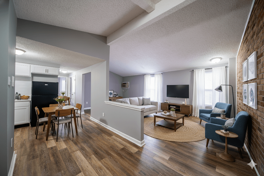 A living room with a couch, chairs, and a dining table.